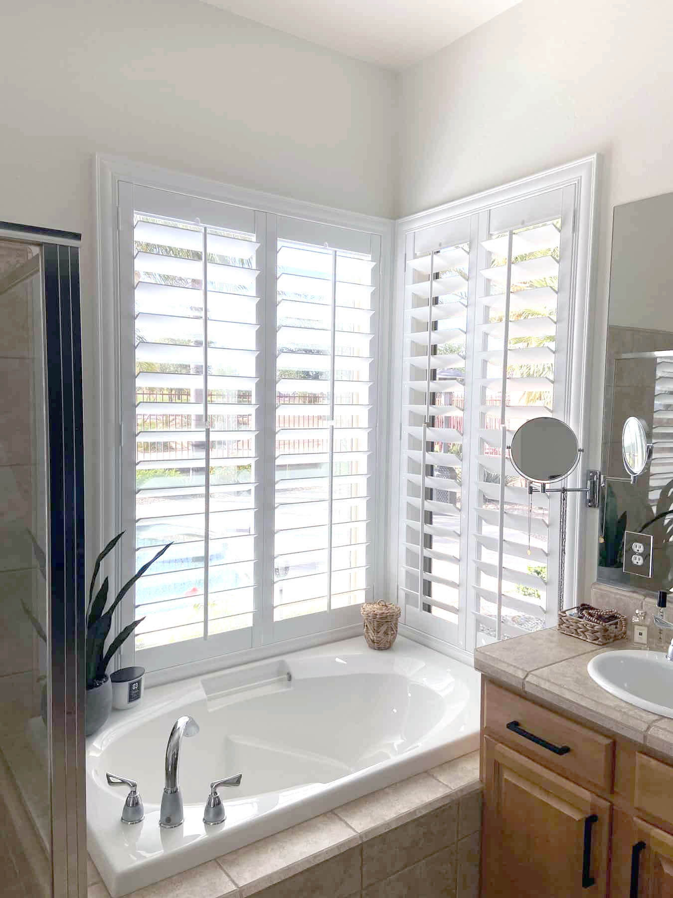 White Polywood shutters on a bathroom corner window