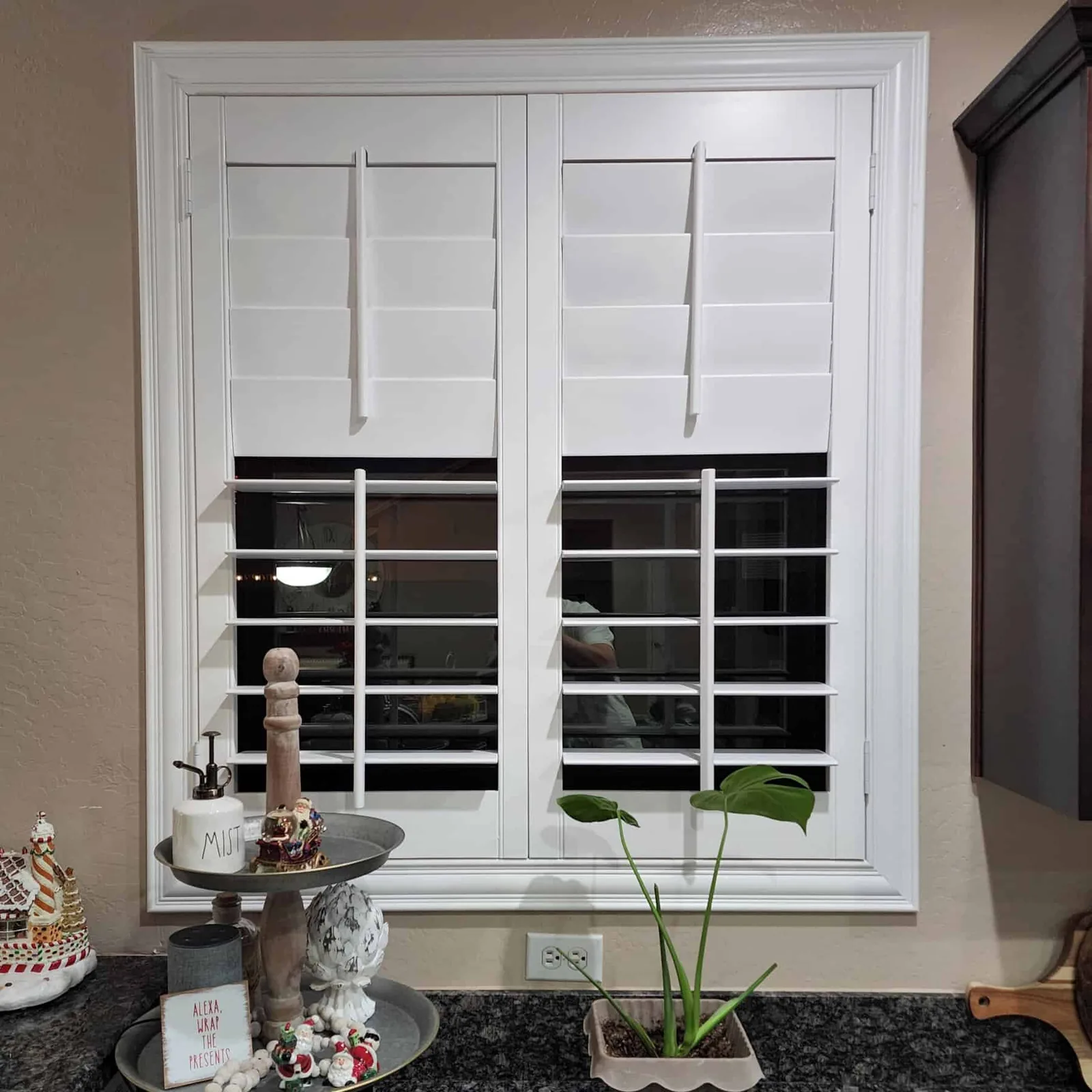 White Polywood shutters on a black-framed double window
