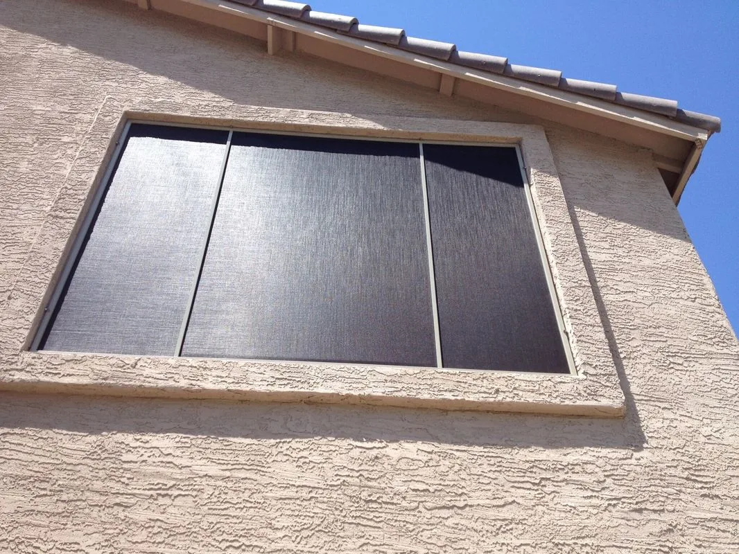 Second-Story Window, a three-panel sun screen on a high gable-end window under a tile roof